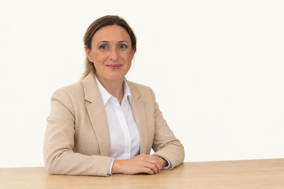 Agata Szymajda, founder of Legato, seated at her desk
